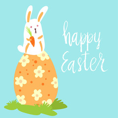 Happy Easter card template with cute white bunny holding a carrot sitting on a big decorated egg on blue background. Hand written lettering.