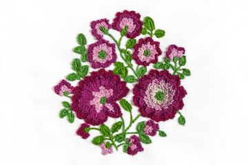 Embroidery bouquet of flowers in purple on white fabric with smooth handwork, trend 2018