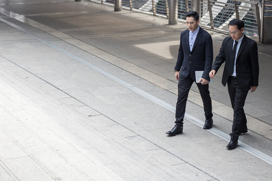 two business talking with partner about business and invetment and step up on stair to office.