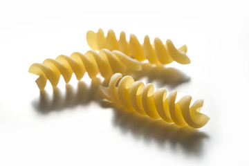 Fototapeta premium Three pieces of Fusilli pasta isolated on white background