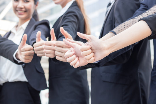 Compliment of teamwork, businesspeople show thumb to praise and great sign for parthner.