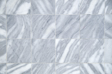 New gray and white marble tiles on wall closeup