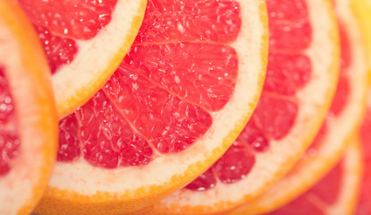 Naklejka na ściany i meble Slices of grapefruit close-up. Macro. 