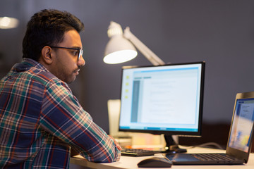 creative man working with laptop at night office