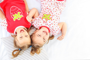 Two children lie in a pajamas bed. Copy space. The concept of childhood, lifestyle, morning. The...