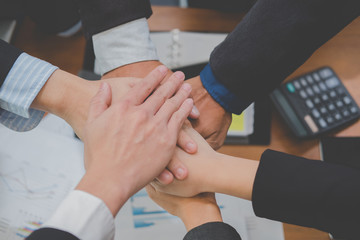 Obraz premium businessman joining hand, business team touching hands together - unity, harmony, teamwork, partnership, collaboration, corporate concept.