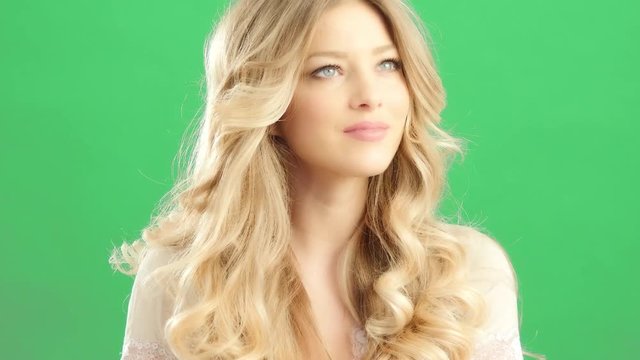 blonde woman with natural look smiling on greenback