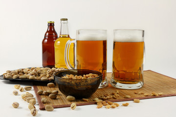 Still life with beer mugs and pistachios in light colors