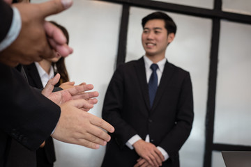 cheerful businessman applauding at conference. successful business team clapping hands for great work