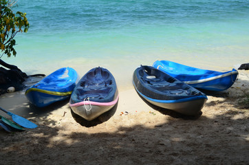 Obraz premium Kayak boat on the beach with blue sea, under shady