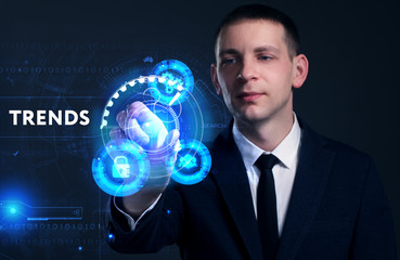 Business, Technology, Internet and network concept. Young businessman working on a virtual screen of the future and sees the inscription: Trends