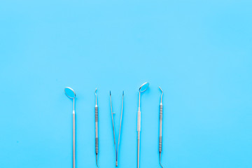 Dentist tools. Teethcare, dental health concept. Blue background top view copy space