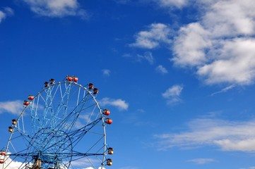 Ferris wheel against the blue sky