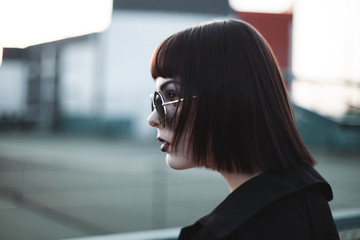 A young woman with short hairstyle in profile. Close up