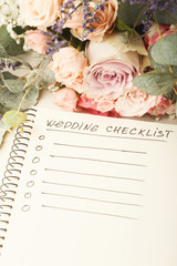 Wedding checklist and rose bouquet