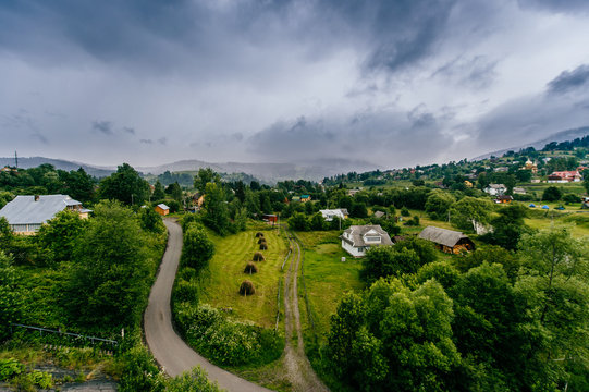 Picturesque fairy tale landscape with a view at railway bridge and mountains covered with stormy rainy clouds. Fantasy colorful scenic route Hills and river. Tourist destination in Carpathians.