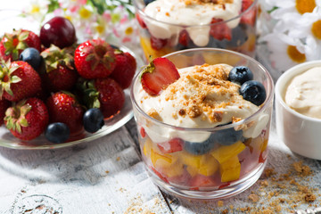 fresh fruit dessert with custard in glasses, top view
