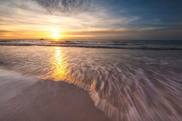Sunset seascape at Kudat Sabah Malaysia. With waves trails and stunning sunset sky.
