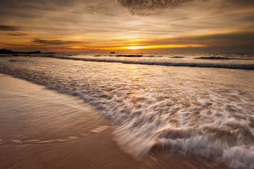 seascape  during golden sunset with waves trails.