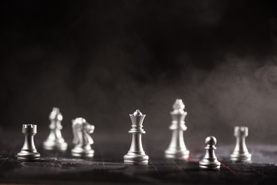silver chess standing in the mist illustrate crisis and strategy concept
