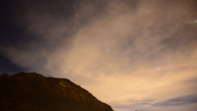 night sky with clouds and orion constellation time lapse