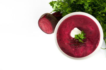 Beet soup in white bowl isolated on white background. Top view copyspace
