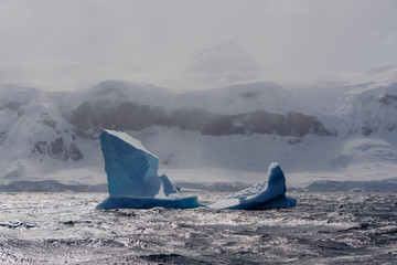 Iceberg in stormy Antarctic sea