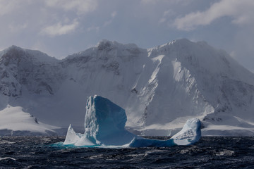 Iceberg in stormy Antarctic sea