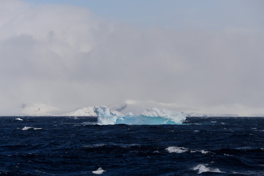 Iceberg in stormy Antarctic sea
