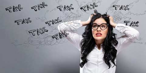 Tax with young business woman feeling stressed