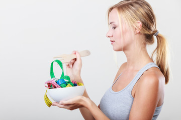 Diet. Girl with colorful measuring tapes in bowl