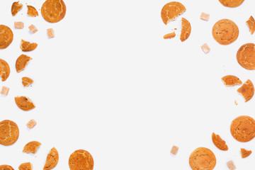 Broken cookies and cane sugar cubes on white, copyspace, flatlay frame arrangement