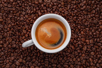 A cup of coffee on a wooden table.