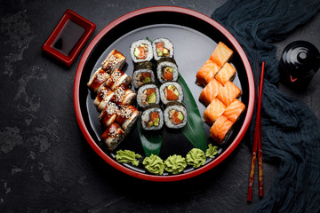 Japanese cuisine. Sushi set over dark background.