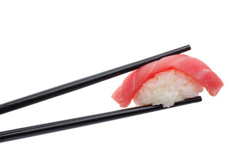 Japanese cuisine. Sushi nigiri in chopsticks isolated on white background background.