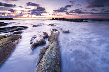 beautiful view of sunset seascape with green moss at Kudat, Sabah Malaysia.