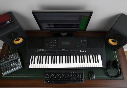 Home recording studio with professional monitors and midi keyboard. Top view.