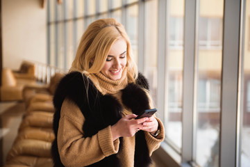 beautiful business woman writing sms on a mobile phone