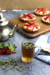 Fototapeta na wymiar arabic tea on glass teacup with delicious strawberry tart