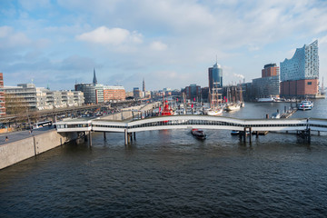 Hamburg, Germany - January 2018. The embankment of the city with standing boats and yachts in the parking lot on the background of the building of the Philharmonic