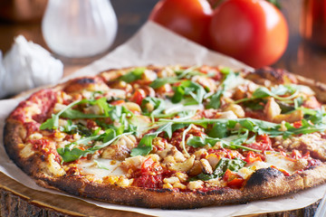 rustic wood fired pizza with roasted garlic and arugula