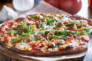 rustic wood fired pizza with roasted garlic and arugula