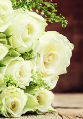 Bouquet of white roses for women's day, wooden background, selective focus