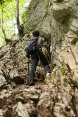 Young man climbing in the mountains