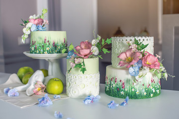 Wedding spring cake decorated with colorful flowers and hydrangeas. Desserts for a festive summer mood