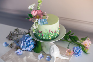 Wedding spring cake decorated with colorful flowers and hydrangeas. Desserts for a festive summer mood