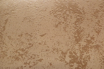 golden fabric closeup background backdrop beige on golden yellow sand stucco wall uneven surface vintage wall upholstery natural material textiles