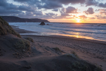Fototapeta na wymiar Dunes above Widemouth at sunset