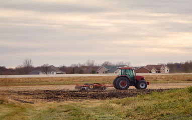 Obraz premium Tractor Pulling a Disk