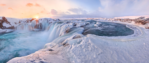 Godafoss frozen waterfall during Winter at sunrise. North Iceland - Powered by Adobe